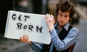 Picture of person holding a sign that says Get Born.